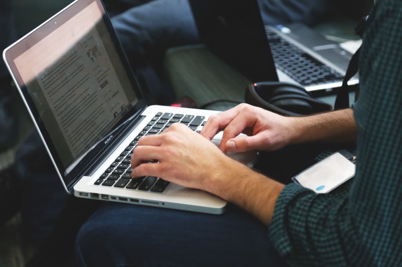 Hands typing on a laptop keyboard